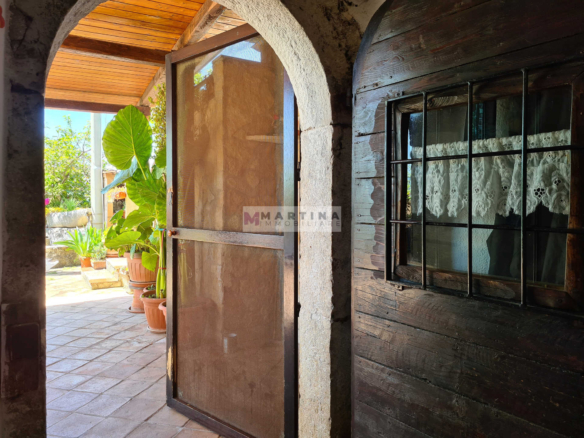 Farmhouse surrounded by greenery
