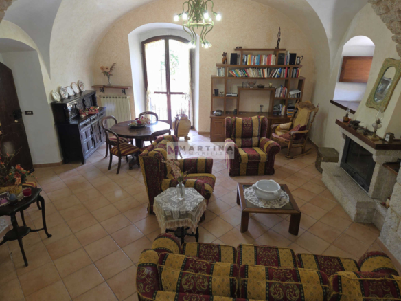 Portion of a three-storey farmhouse with garden