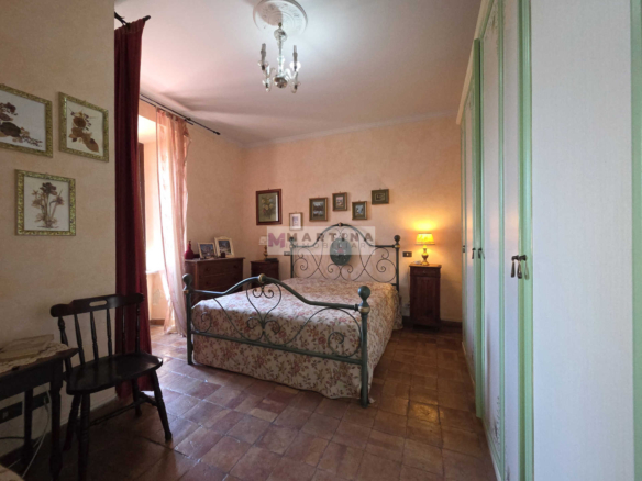 Portion of a three-storey farmhouse with garden