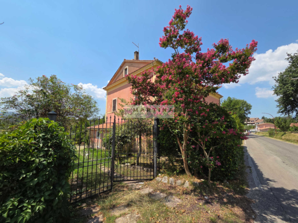 Portion of a three-storey farmhouse with garden