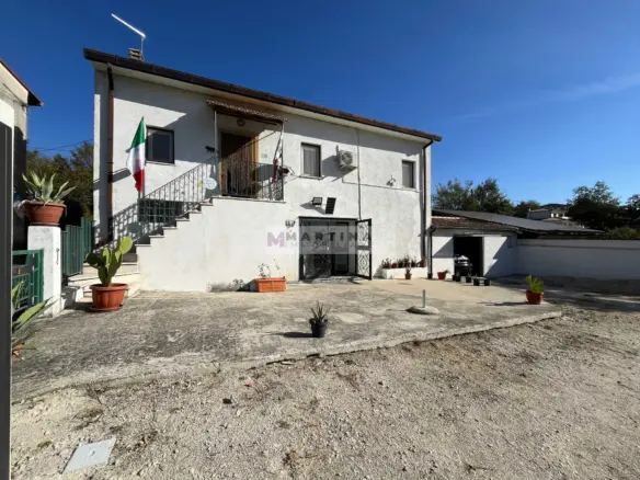 Detached house with garage and land