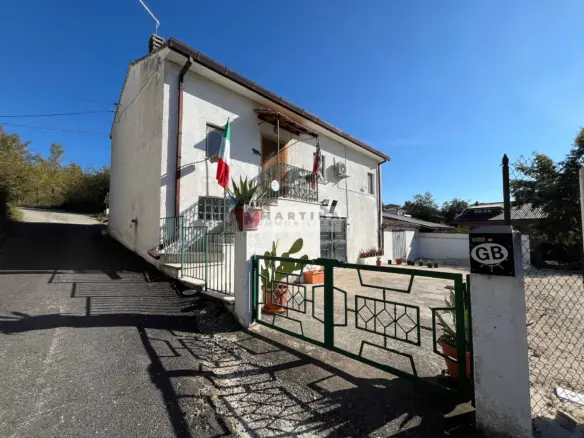Detached house with garage and land